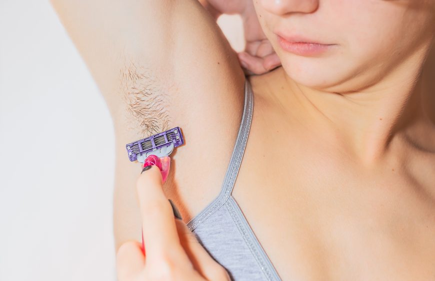 Caucasian,Young,Teenage,Woman,Shaves,Her,Armpit,Hair,With,Razor