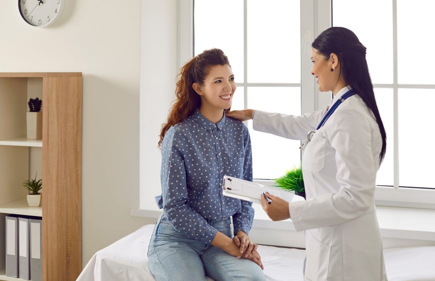 Friendly,Smiling,Female,Doctor,Touches,Patient’s,Shoulder,And,Tells,Her