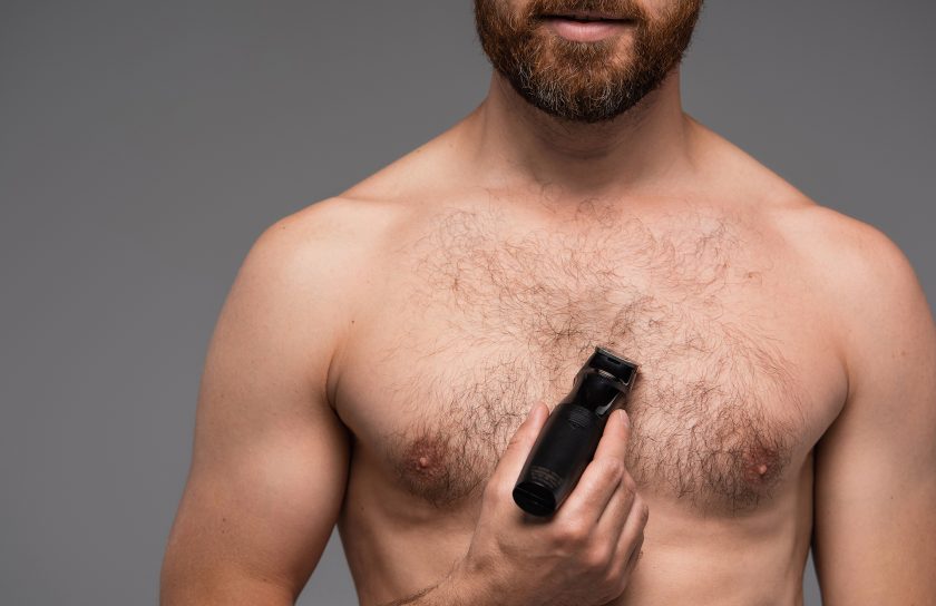 Cropped,View,Of,Shirtless,Man,Shaving,Hair,On,Chest,With